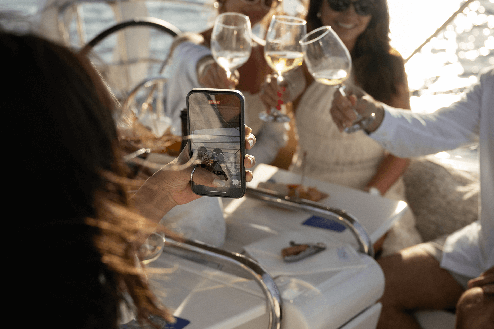 Guests raising their glasses for a photo during a sunset wine tasting